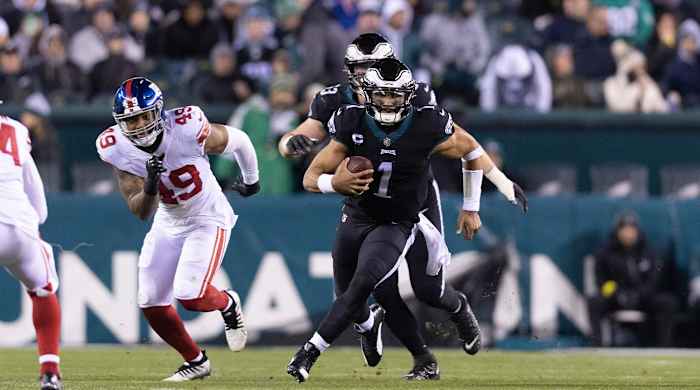 Jan 8, 2023; Philadelphia, Pennsylvania, USA; Philadelphia Eagles quarterback Jalen Hurts (1) runs with the ball in front of New York Giants linebacker Tomon Fox (49) during the third quarter at Lincoln Financial Field.